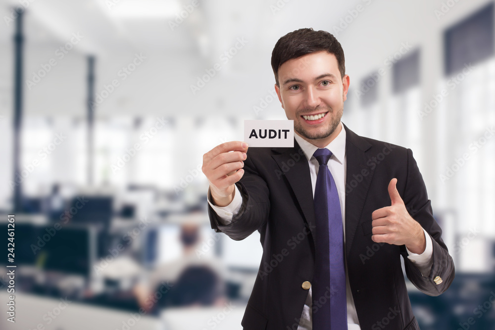 Fototapeta premium Business, technology, internet and networking concept. Young entrepreneur showing keyword: Audit