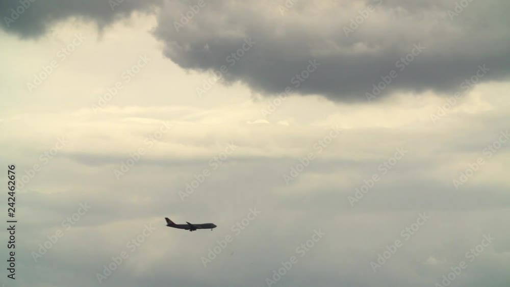Airplane landing amid storm clouds Airplane landing amid storm clouds