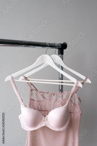 Vareity of pink bra hanging on a hanger. Textile, Underwear. Female bra in lingerie underwear store. Advertise, sale, fashion concept. photo