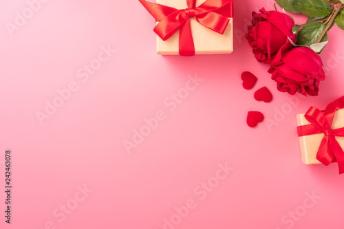 Greeting card concept of giving present at Valentine's, anniversary, mother's day and birthday surprise on pink background, copy space, top view