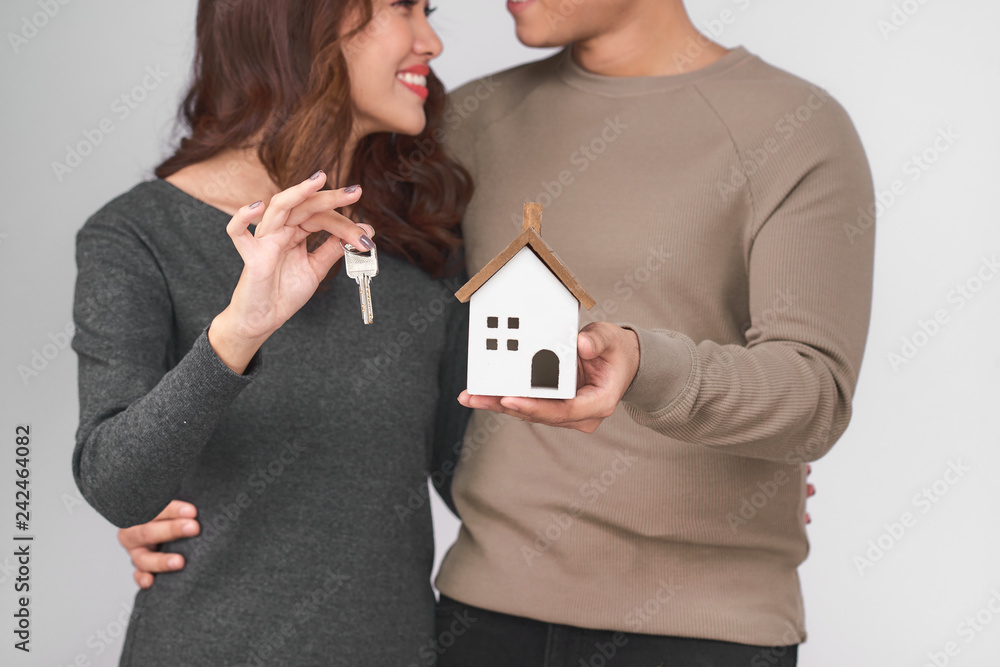 Couple holding key ring to their new house Couple holding key ring to their new house