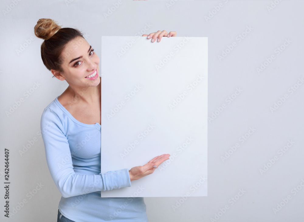 Happy woman showing signboard with blank space for advertisiment Happy woman showing signboard with blank space for advertisiment