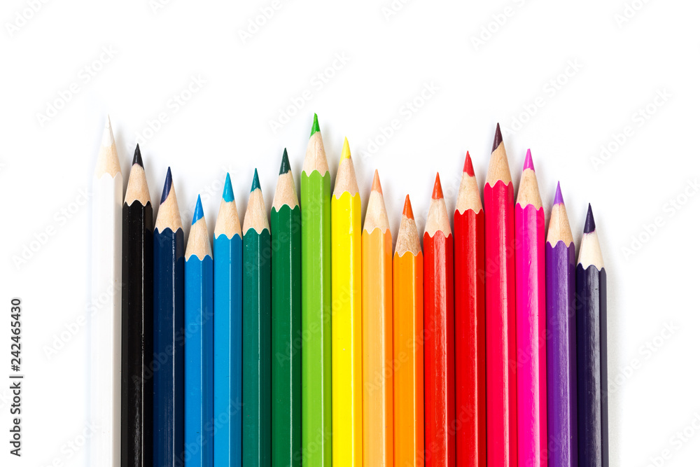 Colour pencils on white background, top view.