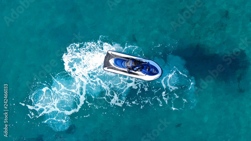 Aerial top view of jet ski cruising in low speed in mediterranean emerald clear waters © aerial-drone