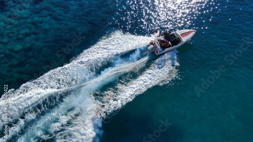 Aerial drone photo of power boat cruising in high speed in deep blue sea