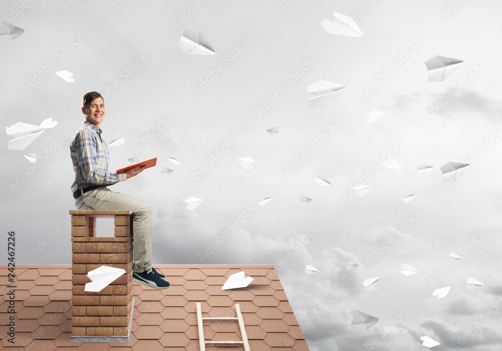 Handsome student guy reading book and paper planes flying in air Handsome student guy reading book and paper planes flying in air