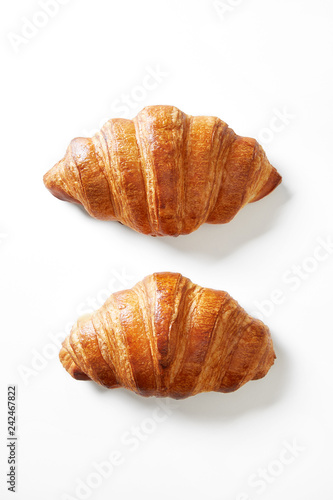 Two croissants isolated on a white background viewed from above. Top view.