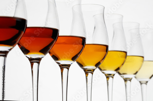 Fotografiet Row of cognac glasses with different stages of aging