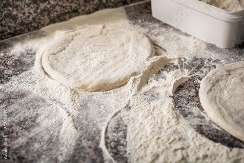 Preparing fresh dough for pizza. Cooking process