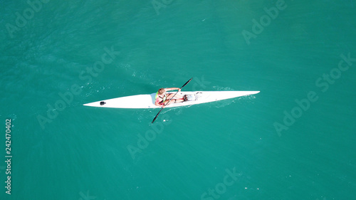 Aerial drone bird's eye view of sport kayak operated a young men in tropical exotic turquoise clear ocean © aerial-drone