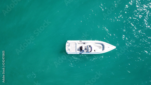 Aerial bird's eye top view photo taken by drone of boat docked in caribbean tropical beach with turquoise - sapphire waters © aerial-drone