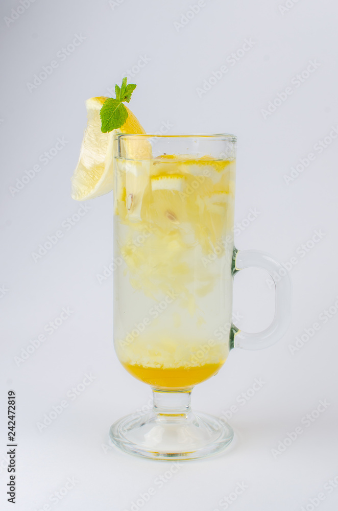 tea with honey, lemon, cinnamon and mint in a clear glass tea with honey, lemon, cinnamon and mint in a clear glass