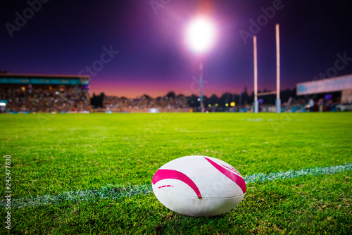 American football, rugby ball on the green grass at the stadium. Professional game in the night. Background sport photo photo