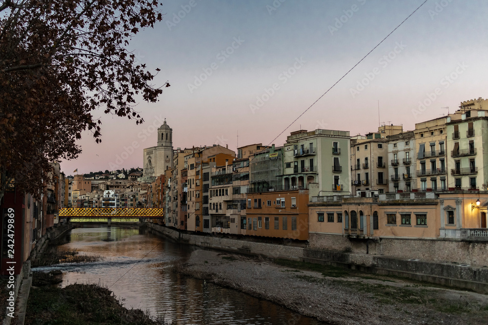 Girona river houses famous landmark at sunset