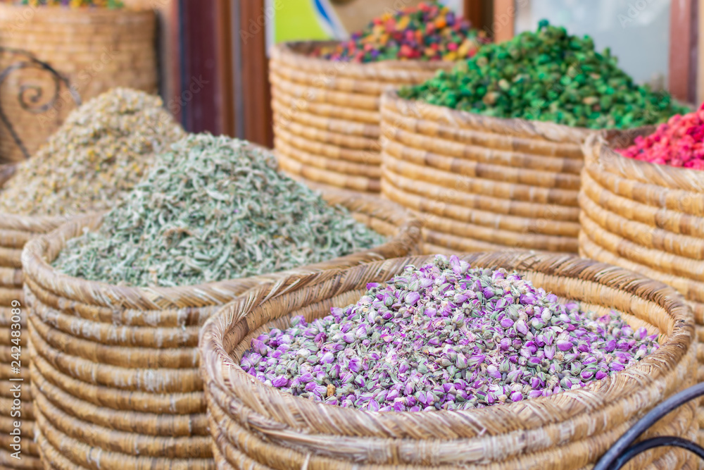 Baskets of colorful natural organic herbal tea in Marrakech market, Morocco. group of beautiful dry colorful flowers. Dried roses , lavender, roselle flower use for decoration mix
