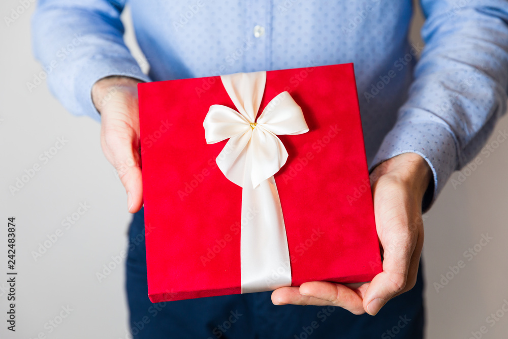 Valentines day gift, close up man holding romantic red Valentines day,anniversary gift. Valentines day gift, close up man holding romantic red Valentines day,anniversary gift.