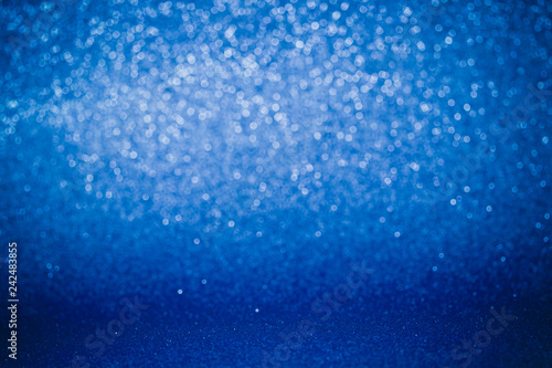 Glitter christmas abstract background. Winter christmas bokeh lights defocused.