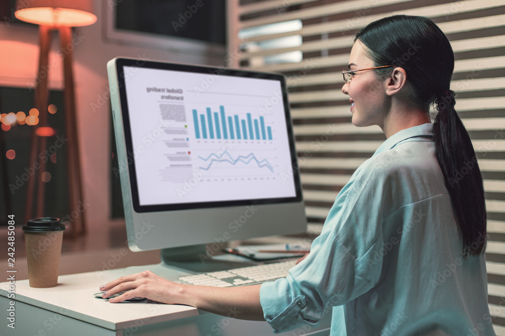 Positive delighted brunette analyzing diagram Positive delighted brunette analyzing diagram