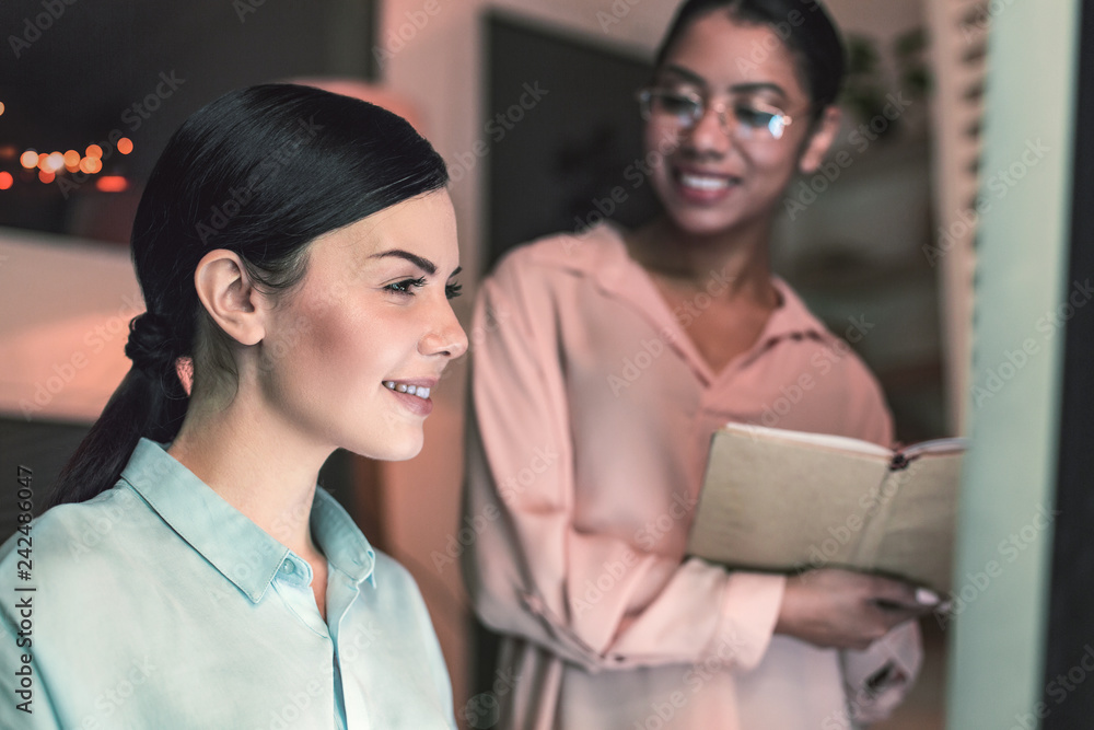Portrait of pleased woman that staring at computer Portrait of pleased woman that staring at computer