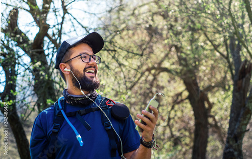 Cheerful man on a hiking trip enjoying time outdoors