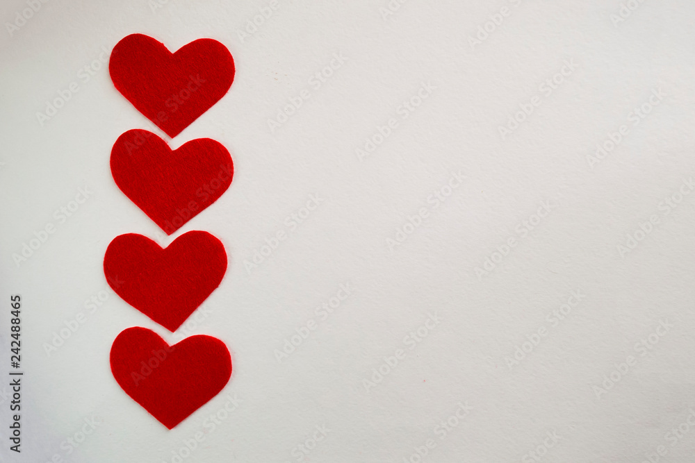 White background with red felt hearts, place for text. Red heart for valentines concept.