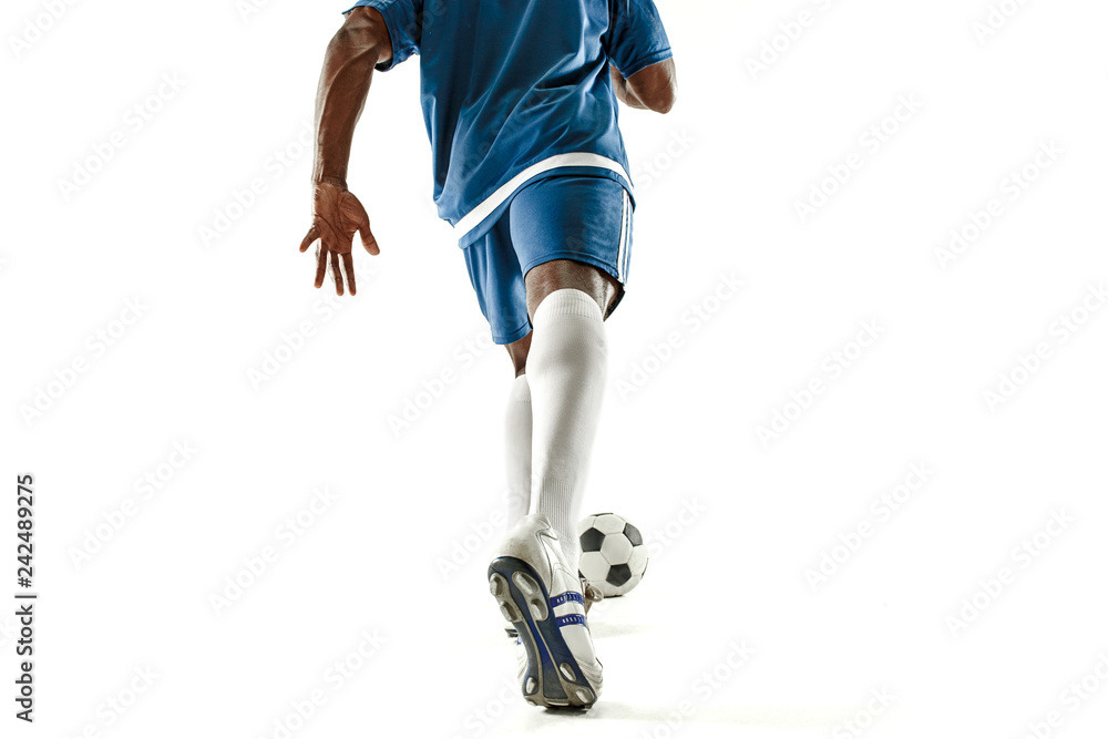 Fototapeta premium The legs of soccer player close-up isolated on white. African american model in action or movement with ball. The football, game, sport, player, athlete, competition concept
