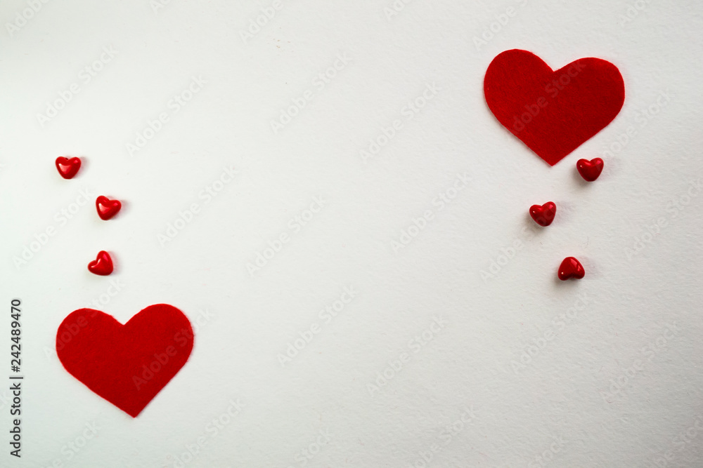 Top view with space for your greeting. White background red small hearts. Valentine's day decoration with copy space