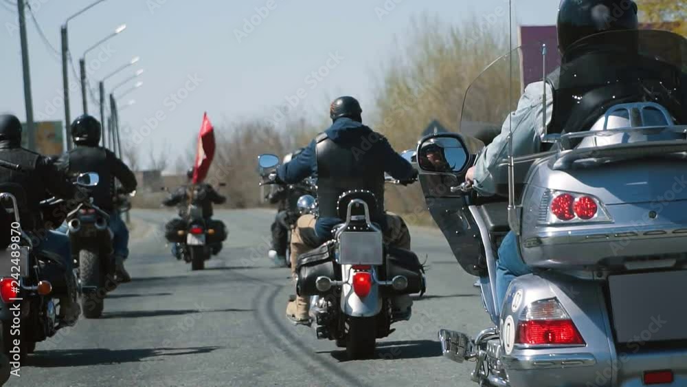 many subculture bikers group ride on the track on a Sunny summer day on custom motorcycles, a large-scale action of motorcyclists many subculture bikers group ride on the track on a Sunny summer day on custom motorcycles, a large-scale action of motorcyclists