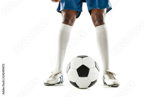 The legs of soccer player close-up isolated on white. African american model in action or movement with ball. The football, game, sport, player, athlete, competition concept