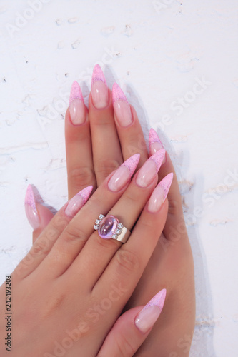 Long French nails with white manicure on a woman's hand.