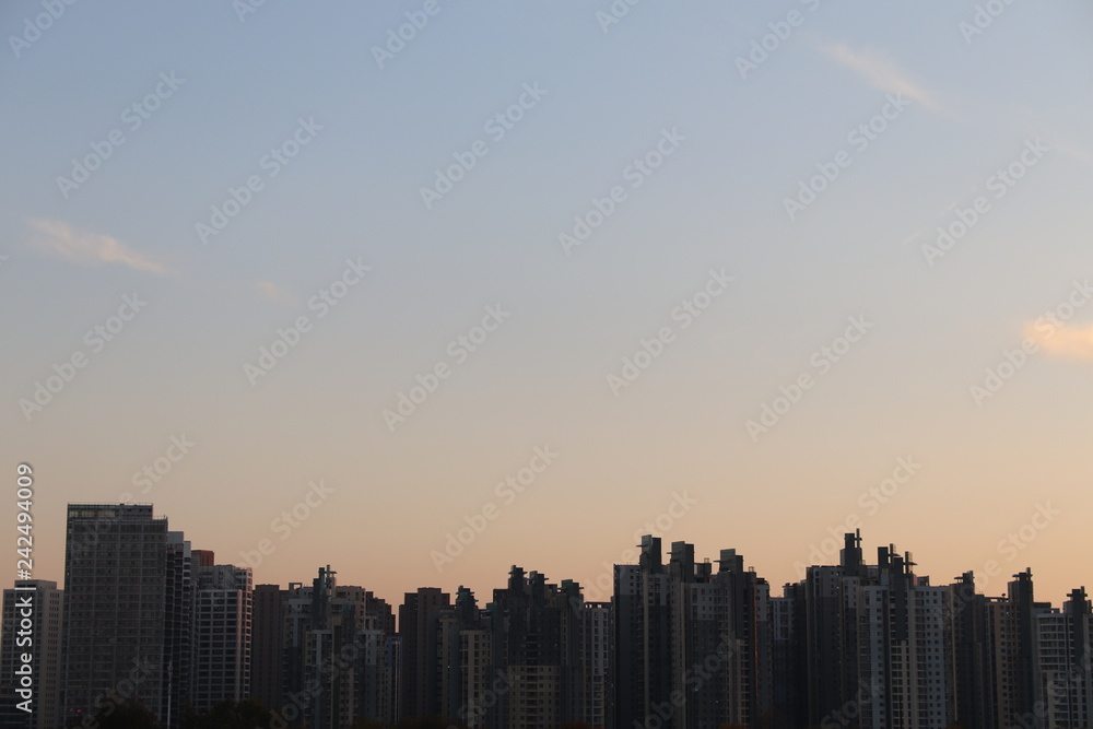 Fototapeta premium Tianjin chisese skyline with the sunset gradient and light clouds in the background blue to yellow