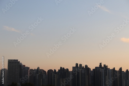 Tianjin chisese skyline with the sunset gradient and light clouds in the background blue to yellow