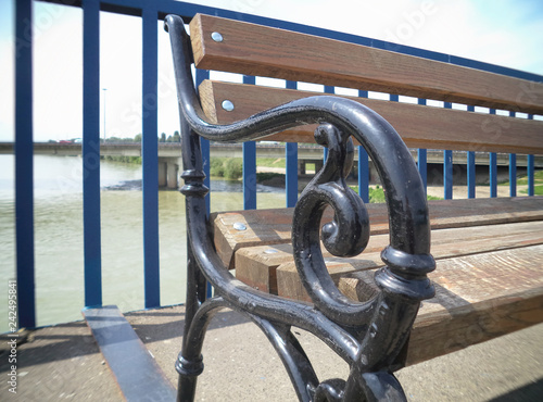 An old wooden bench on the bridge across the river.