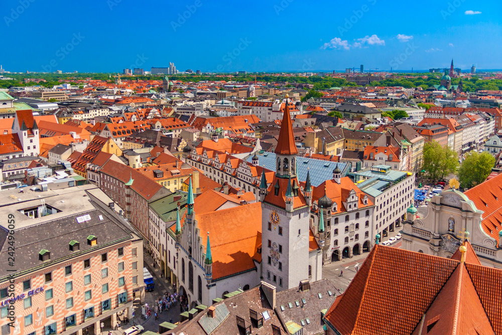 Beautiful aerial view of Munich's cityscape with focus on the Talburg Gate (Talburgtor) at the Old Town Hall (Altes Rathaus) in the front centre on a nice sunny day with a blue sky in Germany.