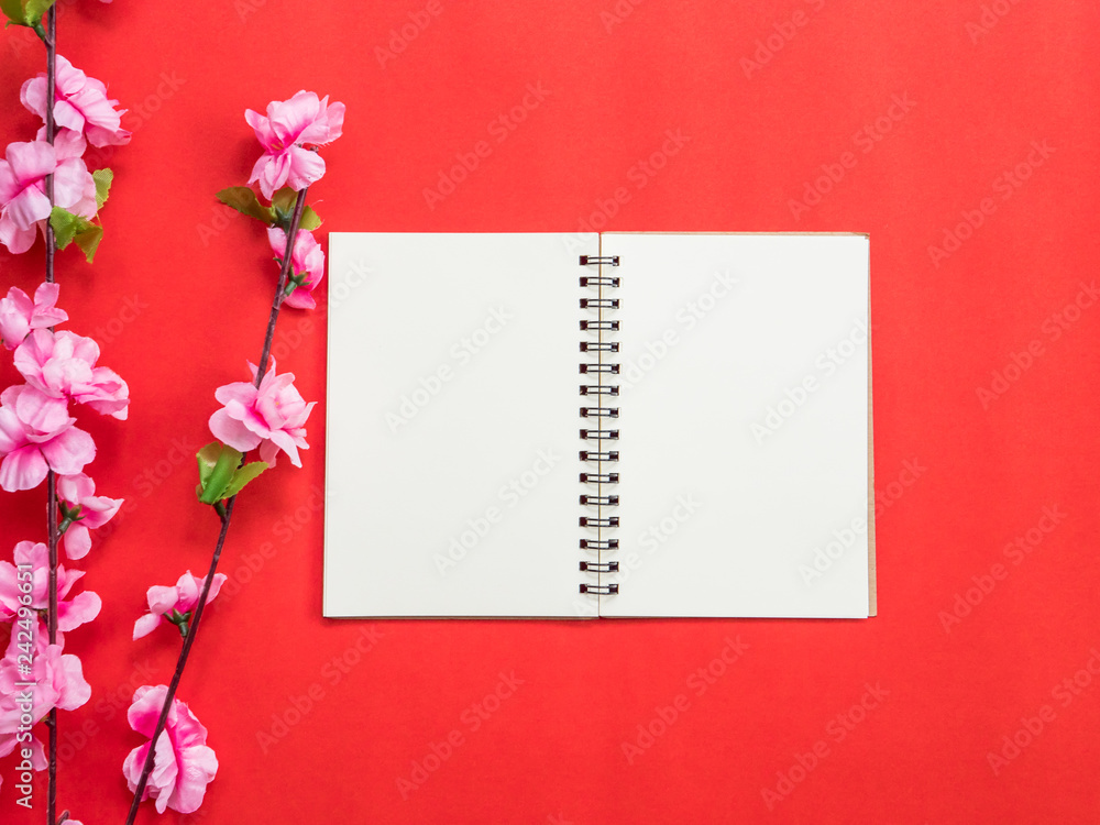 Chinese new year festival decorations, notebook,plum blossom,on red background.