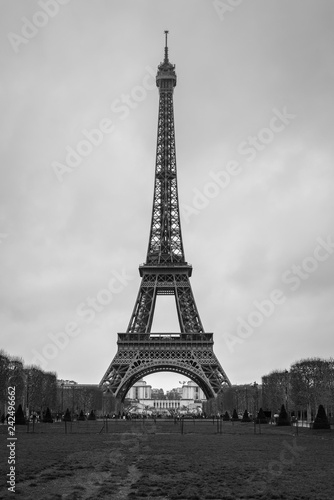 Eiffel Tower seen from Champ de Mars. UNESCO World Heritage Site. Paris landmark in black and white. © Val Traveller