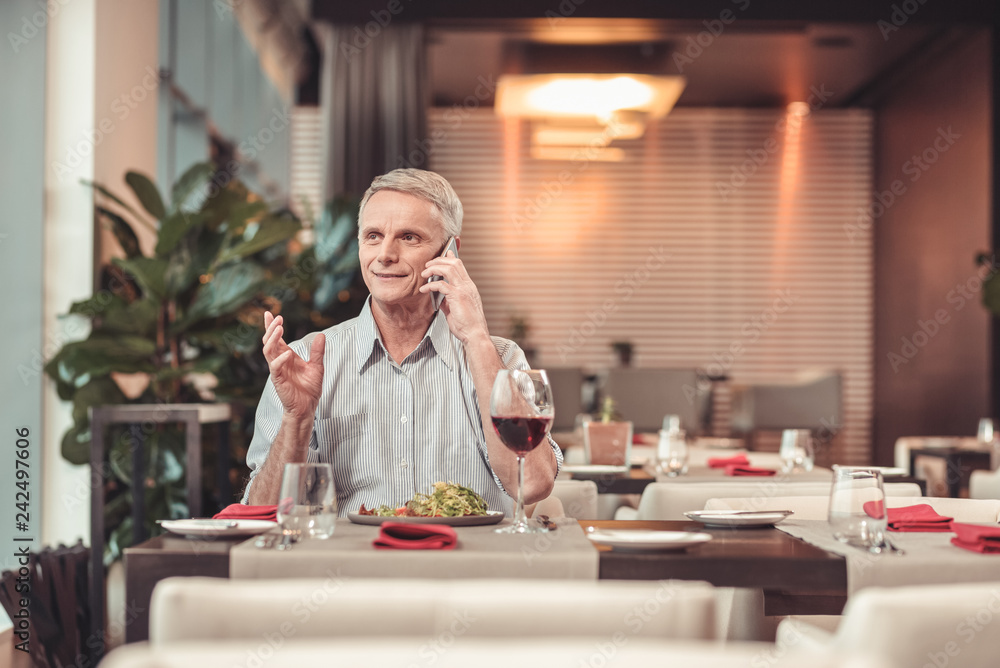 Fototapeta premium Serious man drinking wine in a restaurant