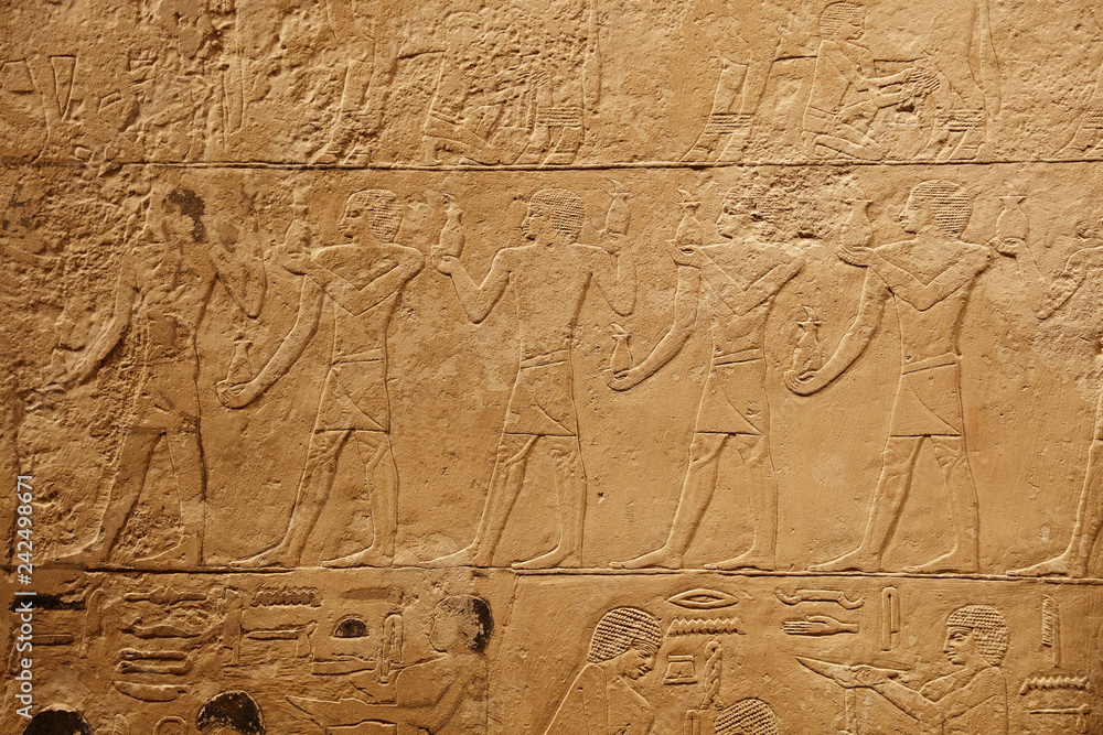 Stone wall with carved ancient Egyptian bas relief