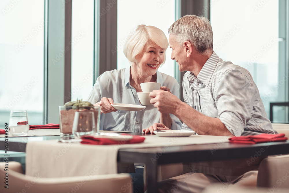 Retired man and woman having morning coffee together Retired man and woman having morning coffee together