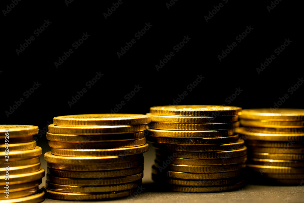 Business background golden coins on black empty space background. Business background golden coins on black empty space background.