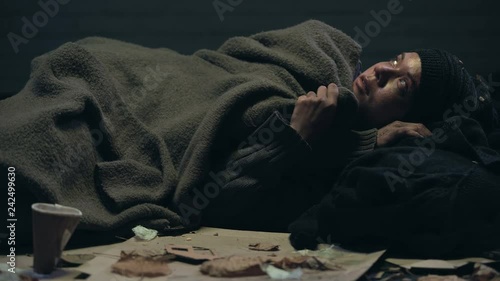 Crying emigrant lying on street, dreaming about home and family, losing hope