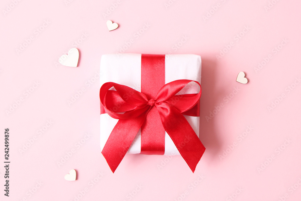 Gift and hearts on a colored background top view. Background to Valentine's Day, Mother's Day, International Women's Day. Gift and hearts on a colored background top view. Background to Valentine's Day, Mother's Day, International Women's Day.
