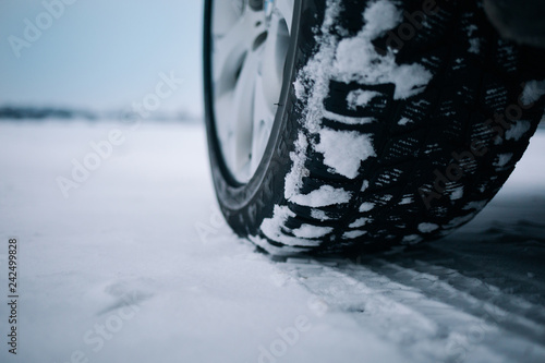 Car tires on winter road covered with snow © Moose