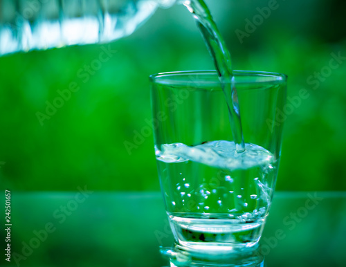 Drinking water in a glass on a wooden table