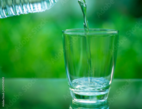 Drinking water in a glass on a wooden table