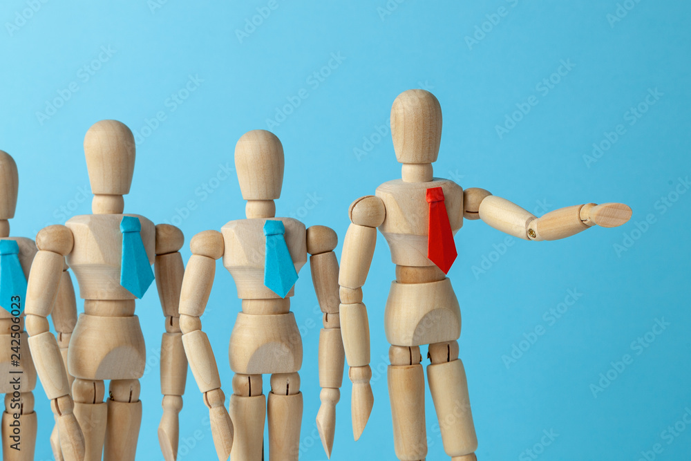 The leader shows the way for the business team to good goal. The leader in red tie shows the direction of his hand business team in blue ties.