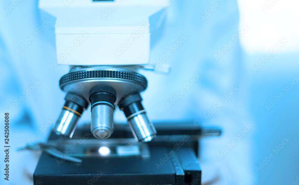 doctor supervisor looking at the microscope slide in the forensic,Laboratory Medical scientists working at lab with test tubes researcher performs liquid doctor supervisor looking at the microscope slide in the forensic,Laboratory Medical scientists working at lab with test tubes researcher performs liquid