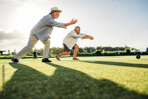 Old men playing a game of boules together photo