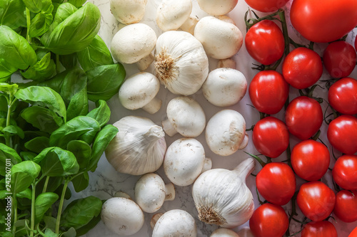 Italian flag made of ingredients for classic Italian food. Basil, mushrooms, garlic and tomatos.