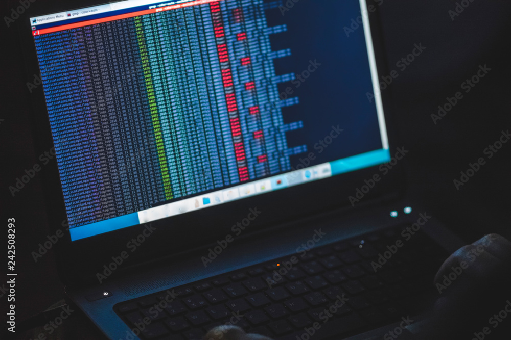 A Computer Programmer Or Hacker Prints A Code On A Laptop Keyboard To A Computer Programmer Or Hacker Prints A Code On A Laptop Keyboard To